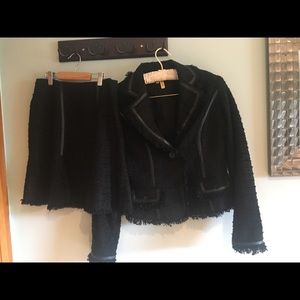 Cache textured black skirt suit with leather trim.